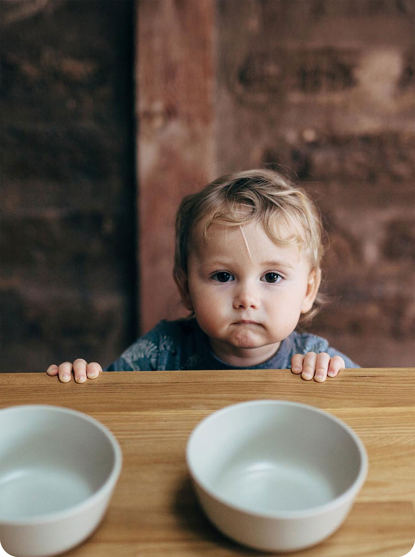 Hungry boy looking at empty bowls