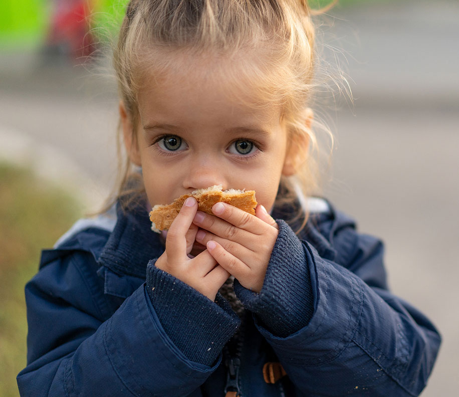 Girl eating a crust of bread